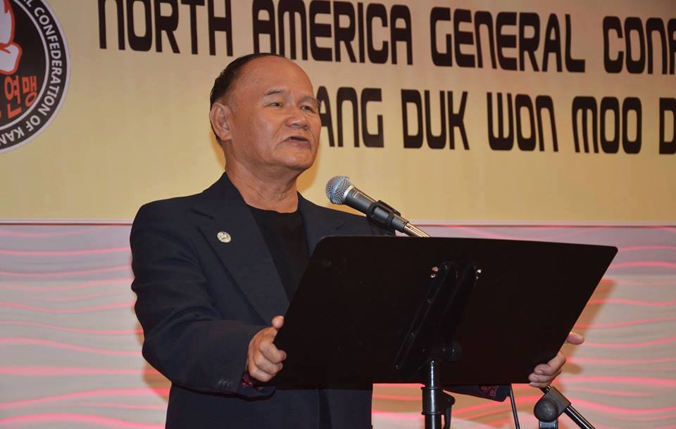 Grand Master Nguyen Kim Châu seen addressing the North America General Confederation of Kang Duk Won Moo Do in 2015