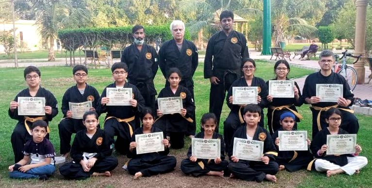 Masters Shahid Mir, Wasim Ahmad and Ahsan Khan, with students at the belt promotion ceremony at the Mir Martial Arts Academy in Karachi in early 2022.