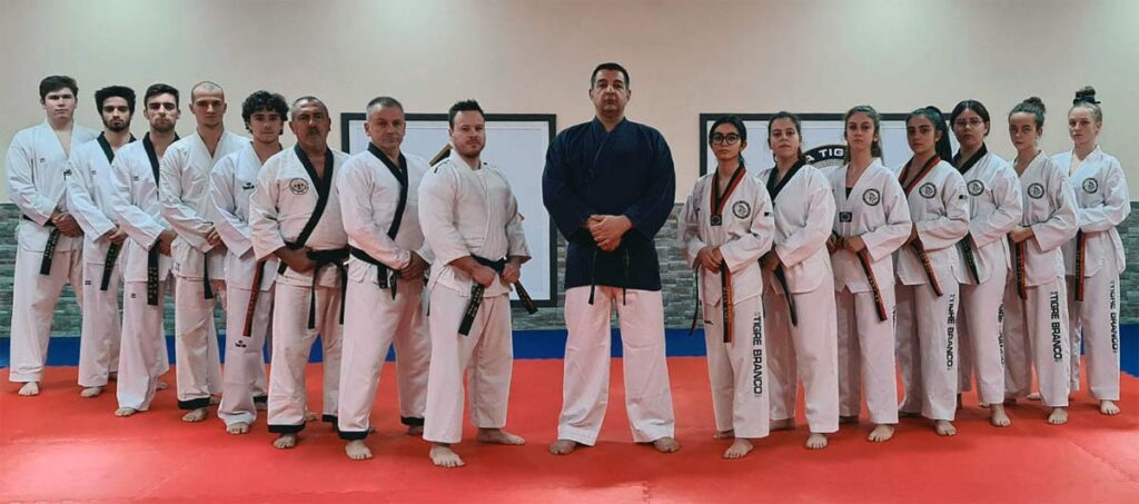 Portugal's Tigre Branco Academy seniors stand beside Taekwondo Kangdukwon Master Fernando Branco
