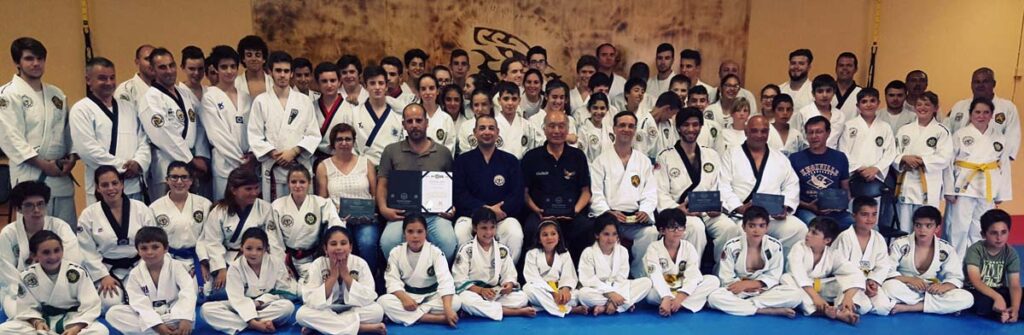 Grand Master Kim Chang-Hak is seen at center flanked by Masters Fernando Branco and Marcelo Ruhland. Promotion exam at Fernando Branco's dojang in Portugal, 27 June 2016.